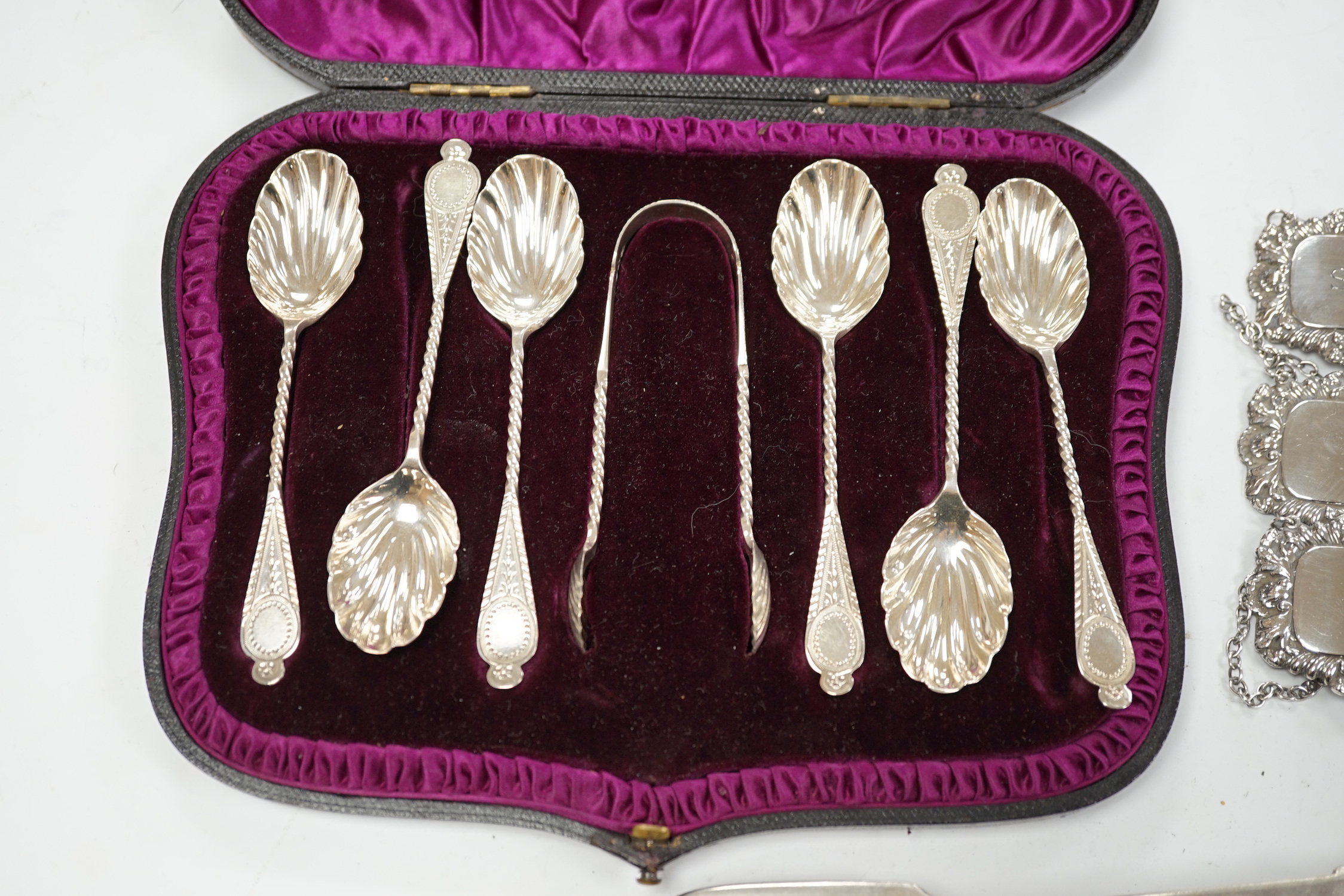 A matched set of five modern silver wine labels, Ray Hall, Sheffield, 1994(3), 1998 & 2000, 61mm, together with two Victorian silver fiddle pattern table spoons, London, 1856 & 1865 and a cased set of six silver coffee s